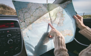 person-holding-map-and-pointing-RocketChip-tips-for-better-mpg-on-your-daily-commute